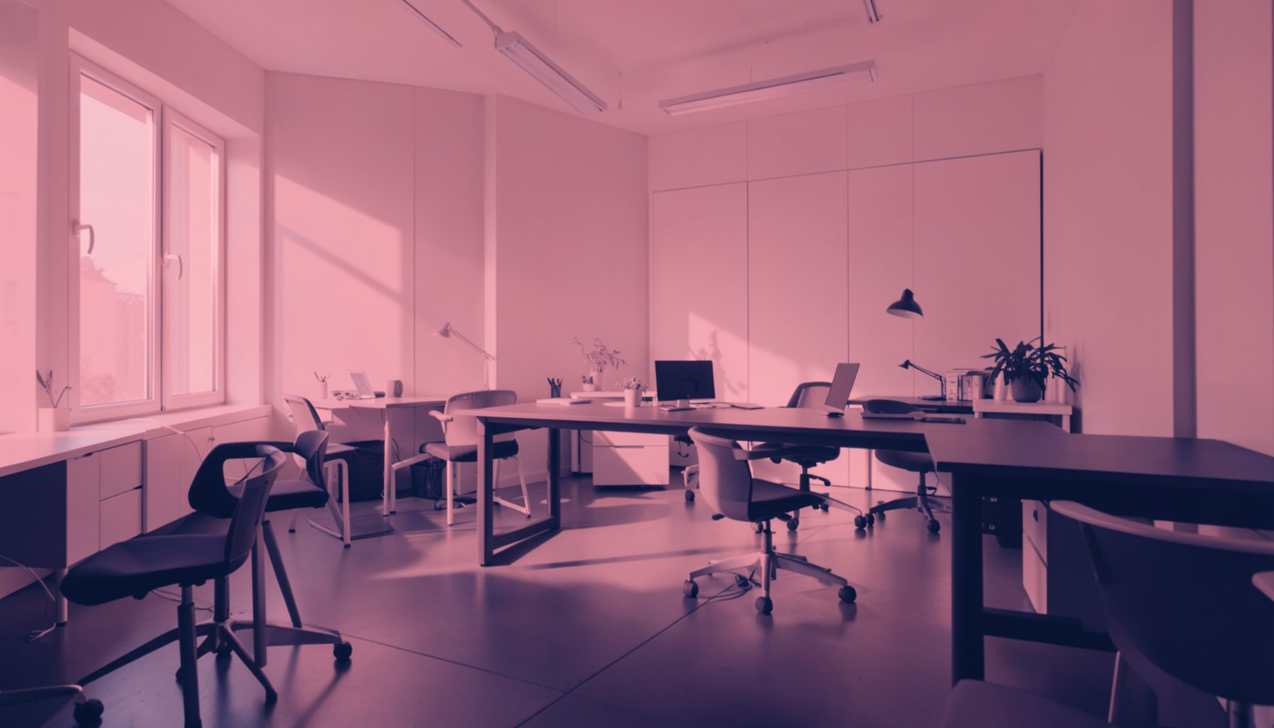 A full-bleed duotone photograph in blush pink and deep navy, showing an atmospheric wide-angle view of a calm, modern workspace